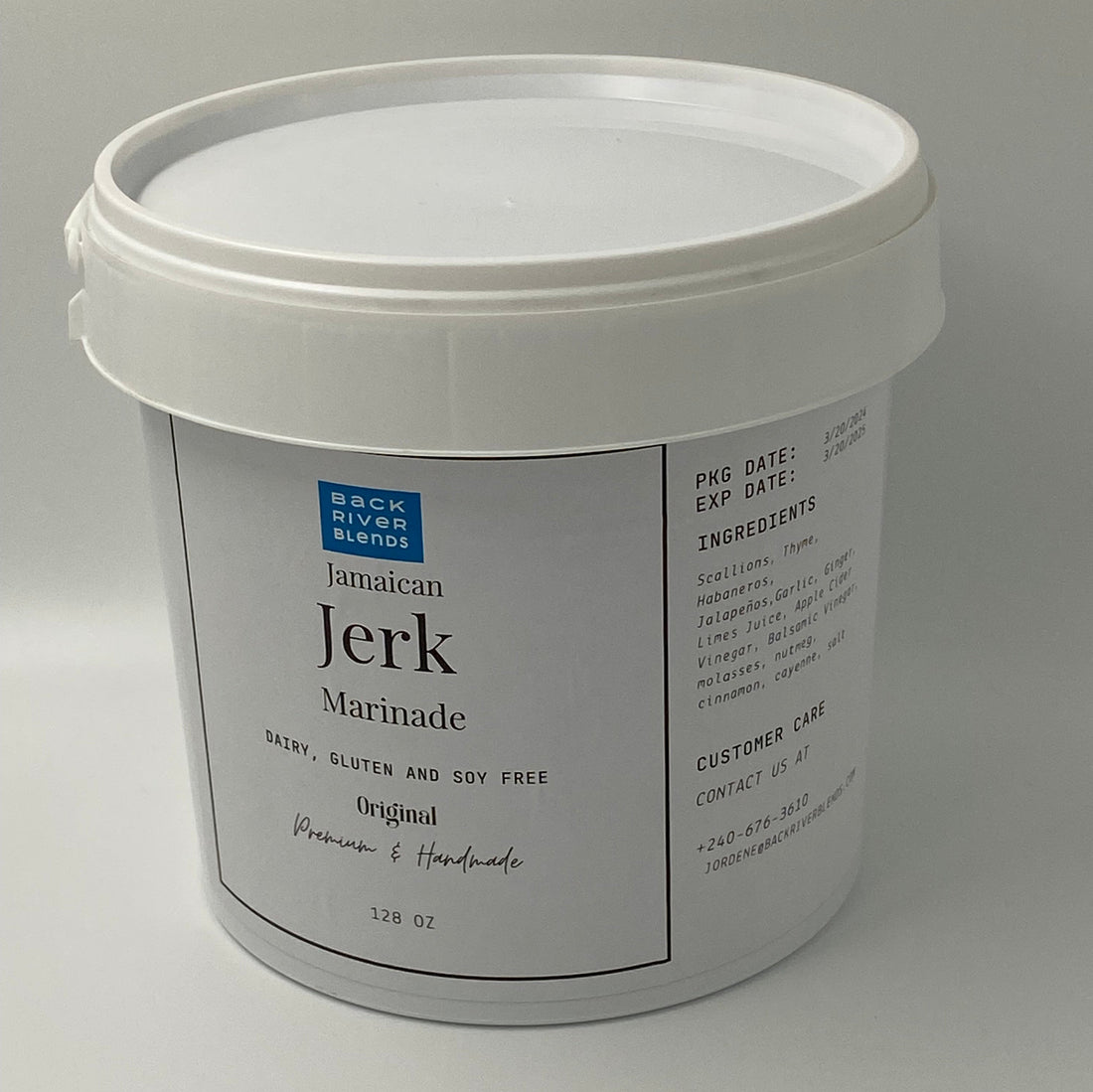 White container Holding Jamaican jerk marinade in gallon size.