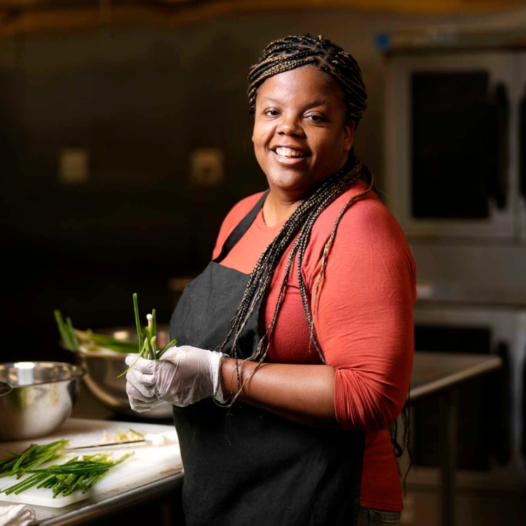 Owner and Creator of Back River Blends in a kitchen making Jerk Marinade